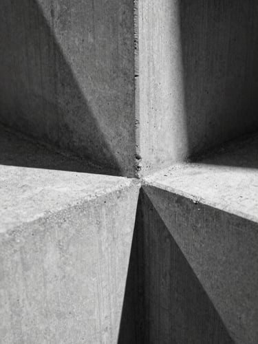 Perfect orthographic macro shot of a cast concrete joint, sharp directional shadows, high-contrast black and white, geometric lines