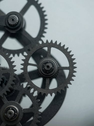 Extreme close-up of high-end mechanical clockwork and technical gears, cool overcast daylight, deep charcoal tones, sharp focus, 35mm