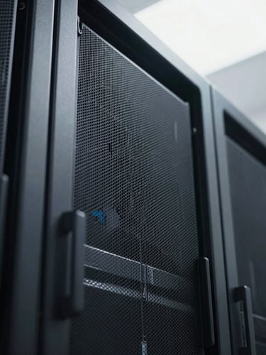Extreme close-up of a high-end server rack with sharp geometric lines, cool overcast daylight, deep charcoal tones, minimalist architectural style, 35mm