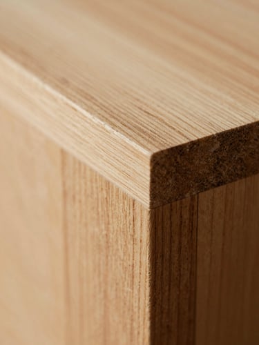 Macro photograph of a hand-sanded timber joint, soft natural side-lighting, rich wood grain detail, shallow depth of field, 35mm