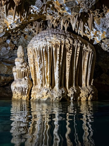 Close-up shot of ancient mineral formations and stalactites inside a Mexican cenote, crystal-clear water reflecting the textures of the stone, high-contrast chiaroscuro lighting