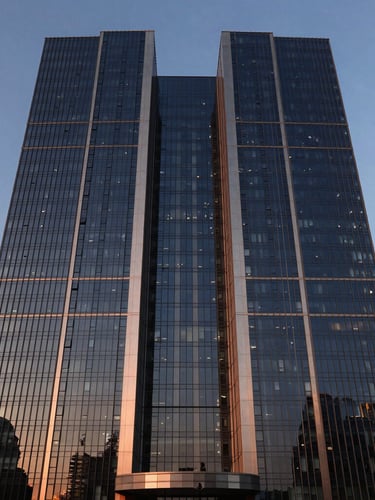 Symmetrical architectural exterior of a modern glass and steel skyscraper in Gurgaon during twilight, sharp reflections, deep navy tones
