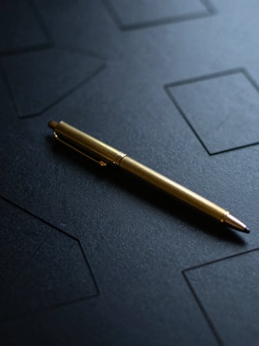 Macro close-up of a matte black desk with a single brass pen resting on structured paper wireframes, sharp architectural shadows, cool diffused daylight, 35mm