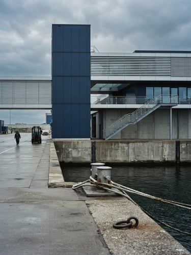 Refined architectural detail of a modern European trade port under cool overcast daylight, minimalist composition, 35mm photography