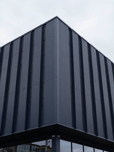 Architectural detail of a clean, modern European port facility, muted corporate navy tones, cool overcast daylight, 35mm.