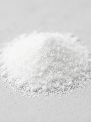 Macro close-up of pure white amino acid powder on a clean, light gray stone surface, bright studio lighting, sharp focus, minimalist composition.