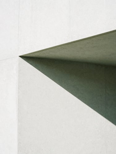 Close-up of a sharp geometric shadow falling on a clean concrete wall, minimalist architectural composition, bright high-contrast natural light, 35mm