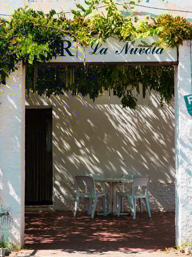 Vintage bar entrance with table and chairs in Alghero, Sardinia