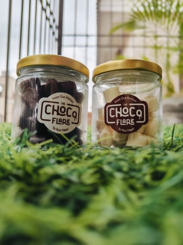 two jars of chocolate covered with chocolates by chocoflare