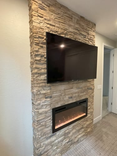 TV mounted by At Hand Heroes on custom block fireplace in Peoria AZ with hidden wiring and clean