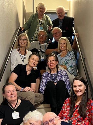 twelve Telelaget members sit in a stairwell