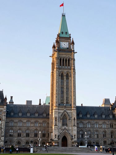 A clean architectural shot of the Parliament of Canada under soft morning light, editorial documentary style