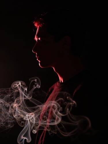 A cinematic portrait of a person in shadow, only their silhouette is visible against a deep black background. A thin rim light in vivid deep red outlines their profile, while subtle off-white smoke swirls in the foreground.