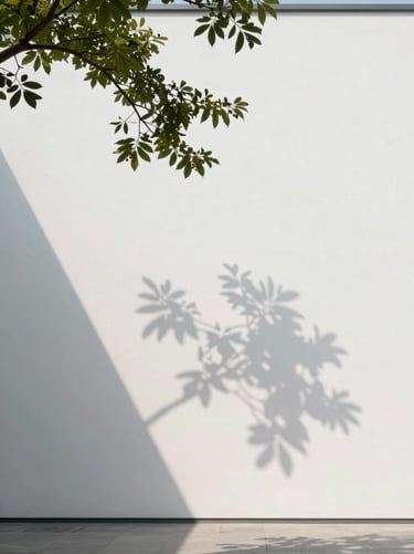 Architectural shadow of a branch falling across a blank white gallery wall, soft diffused indirect daylight, portrait orientation, minimalist composition.