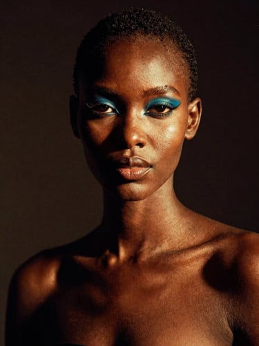 Editorial studio portrait of a Kenyan model with bold makeup, dramatic side-lighting creating rich shadows, deep saturated dark background, 35mm film aesthetic.