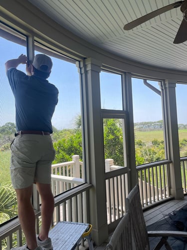 Technician installing screen on a back porch.
