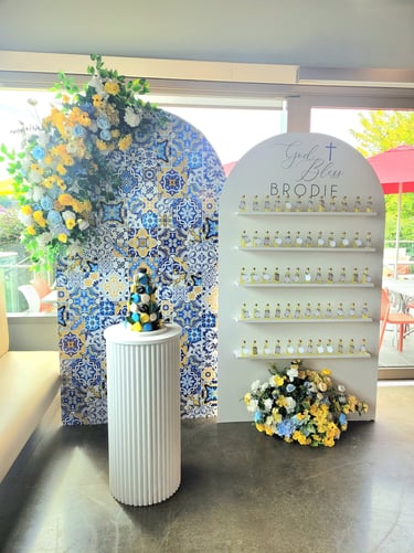 a amalfi backdrop of favor bottles and flowers