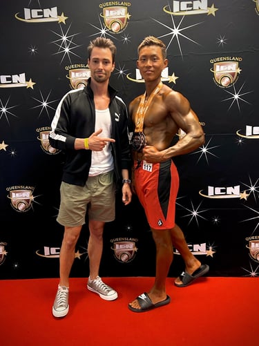 Sho posing with Coach Sasha after winning three medals at ICN Brisbane.