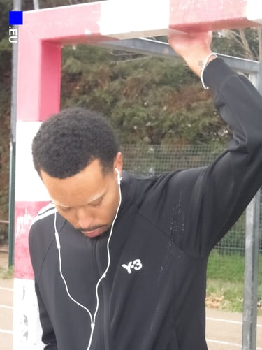 Editorial photo of Kisito during rainy afternoon shoot, showing eccentric fashion style