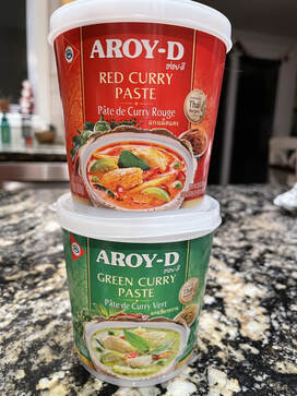 tubs of Aroy-D red and green curry paste 