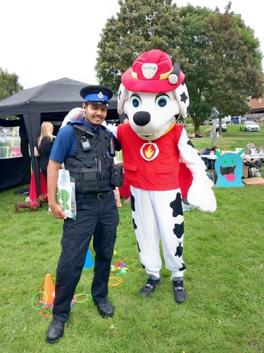 a man in a police uniform standing next to a dog mascot
