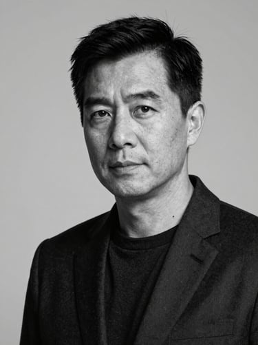 High-contrast black-and-white portrait of a male executive in dark attire, dramatic studio lighting, clinical, sharp shadows, neutral background