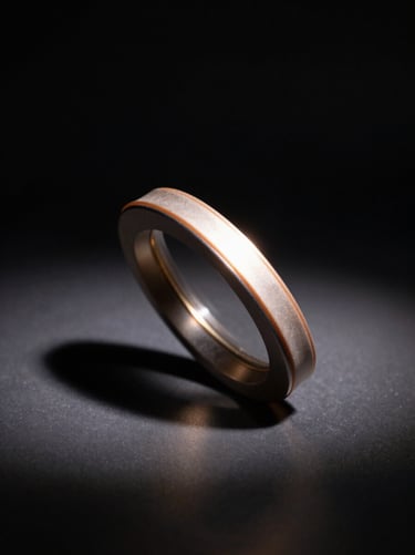 Close-up of a luxury product on a dark reflective surface, single overhead studio strobe casting a precise shadow, deep black background with a thin sliver of warm light revealing the object's edge and material texture