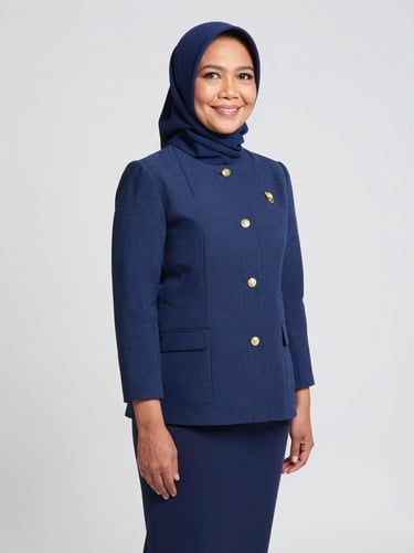 Studio portrait of Indonesian female commissioner, 50s, clean grey background, elegant look, warm wisdom, 35mm lens