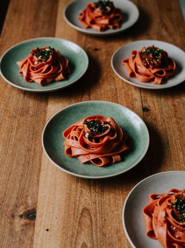 Overhead shot of a rustic wooden dining table with plates of handmade pasta, soft moody shadows, scandinavian daylight