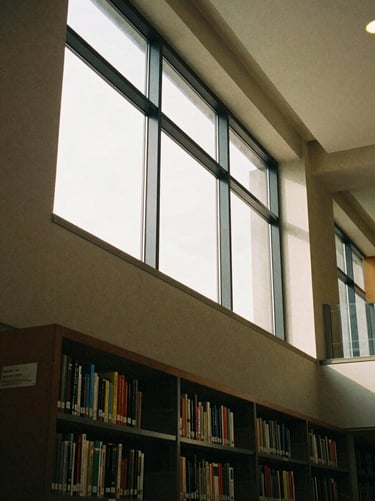 Architectural detail of a modern university library, warm morning light, clean lines, medium format film
