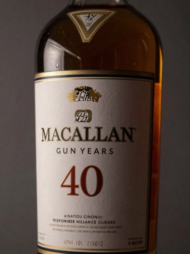 Close-up of Macallan 40 Years single malt whisky bottle, amber liquid reflecting soft golden light