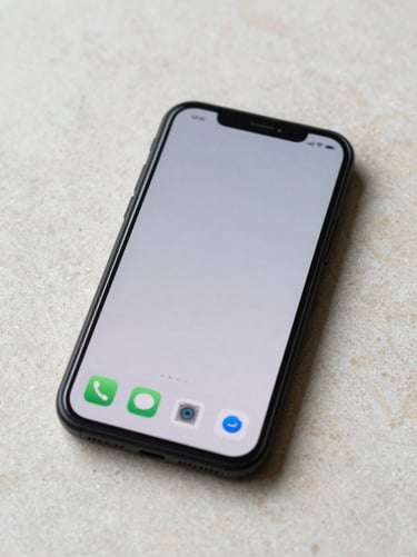 Android phone face-up on a light stone surface, a minimal app home screen with only a few icons visible, early morning soft daylight, clean and unhurried