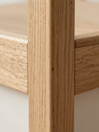 Macro close-up of a premium light oak wood frame corner joint, showing natural grain texture, soft daylight, shallow depth of field