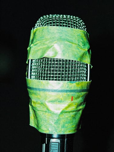 Microphone covered in duct tape, extreme close-up, harsh direct flash, neon green highlights, portrait aspect.