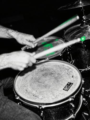 Hands drumming violently on battered snare drum, motion blur, harsh black and white, portrait aspect.