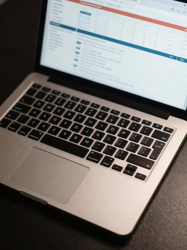 Close-up overhead shot of a laptop keyboard and trackpad on a dark desk, a campaign performance analytics dashboard visible on the screen, cool studio strobe lighting, sharp screen detail, no visible faces