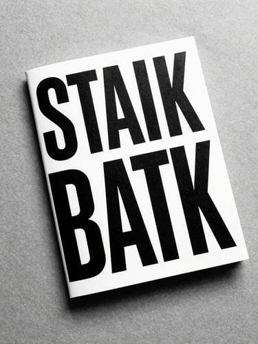 Stark black and white book cover design lying on a textured gray paper surface, minimalist typography, high-contrast overhead shot