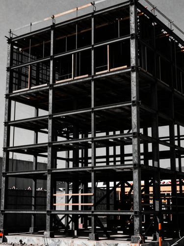 Cinematic wide shot of a physical billboard construction set in harsh midday sun, deep black shadows, stark industrial steel framing, 35mm film