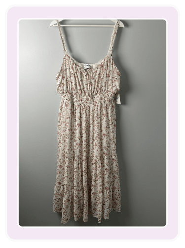 Arula floral smocked midi dress with adjustable straps and a tiered skirt on a hanger.