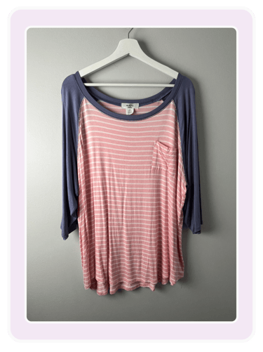 Soft striped pink and white women's baseball tee with blue sleeves, perfect for casual wear and comfort.