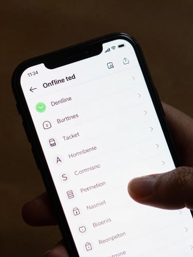 Close crop of an Android phone screen showing a clean task-list interface with offline status indicator, natural overhead desk light, fingers resting near the screen edge