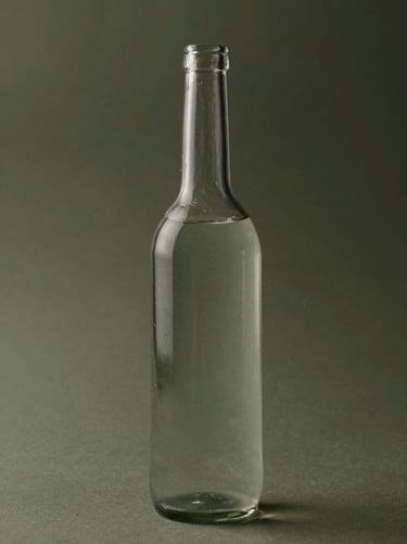 A vertical study of a single tall glass bottle partially filled with water, creating subtle distortions. The style is clean and professional with a muted olive and deep charcoal color scheme.