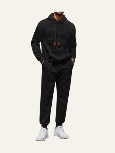 picture of the body of a man wearing a black matching hoodie and jogger set