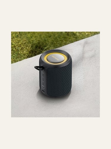Portable Deeyaple Bluetooth speaker in black mesh with yellow accents on a stone surface.