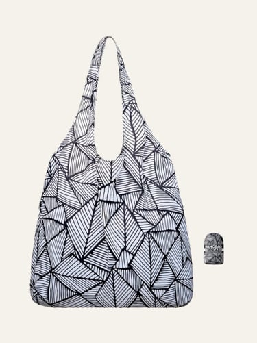Foldable Nanobag reusable grocery tote with a black and white geometric leaf pattern and its compact carry pouch.