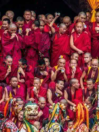 Masked-dancer-with-Monks-in-The-Backdrop-in-Thimphu