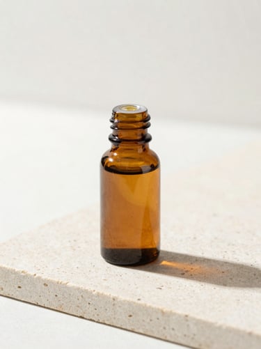 Minimalist amber glass bottle on a light stone surface, soft shadows, sage green accents, macro focus