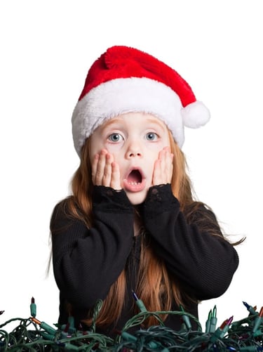 a little girl with a santa hat on her head