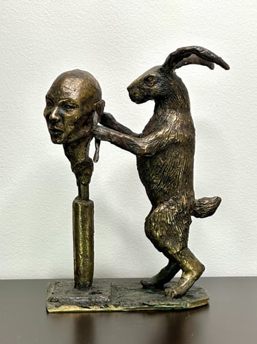 a statue of a rabbit sculpting a human head