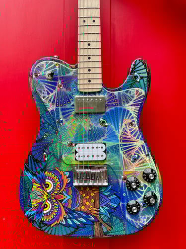 Owel Psychedelic Guitar. Hand-painted by Nancy Elhallak of Graffiti Garage. Donated to the London Roundhouse and signed 